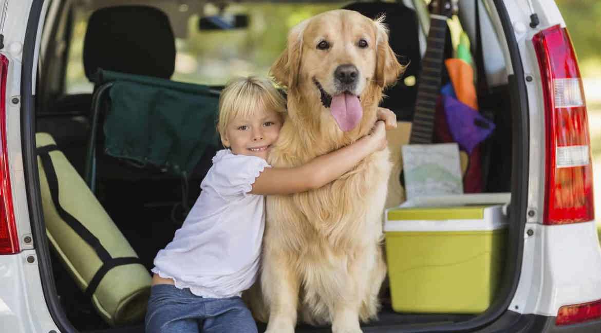 little girl hugging dog