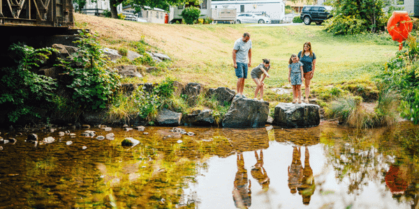 Family exploring by the river at Riverside Leisure Park