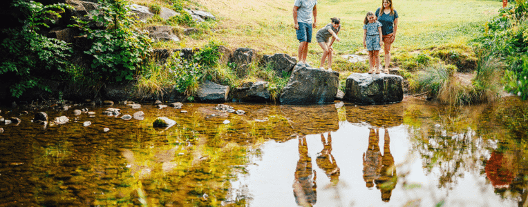 Family exploring by the river at Riverside Leisure Park