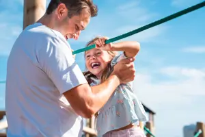 Dad with daughter in play area