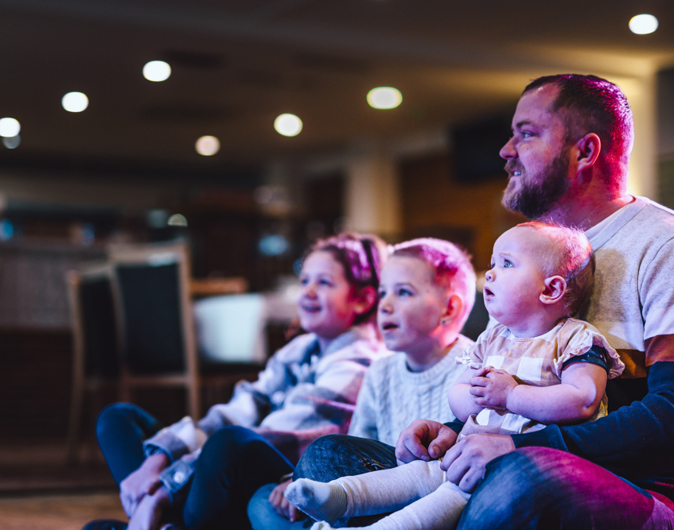 Family watching live entertainment at Golden Coast
