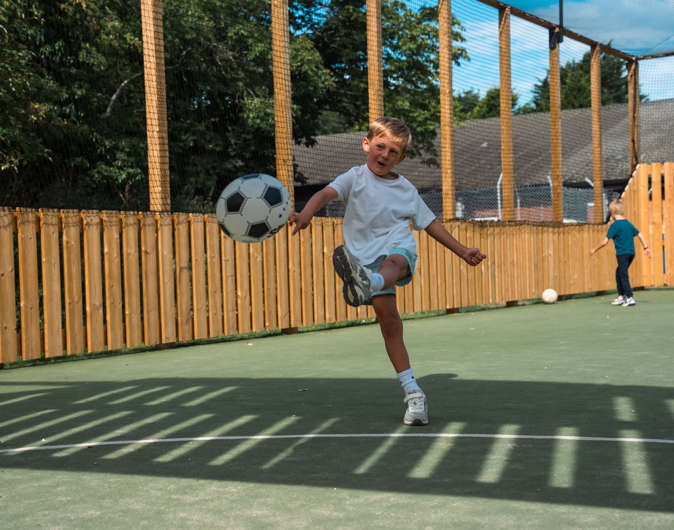 Boy playing in multi use sports court