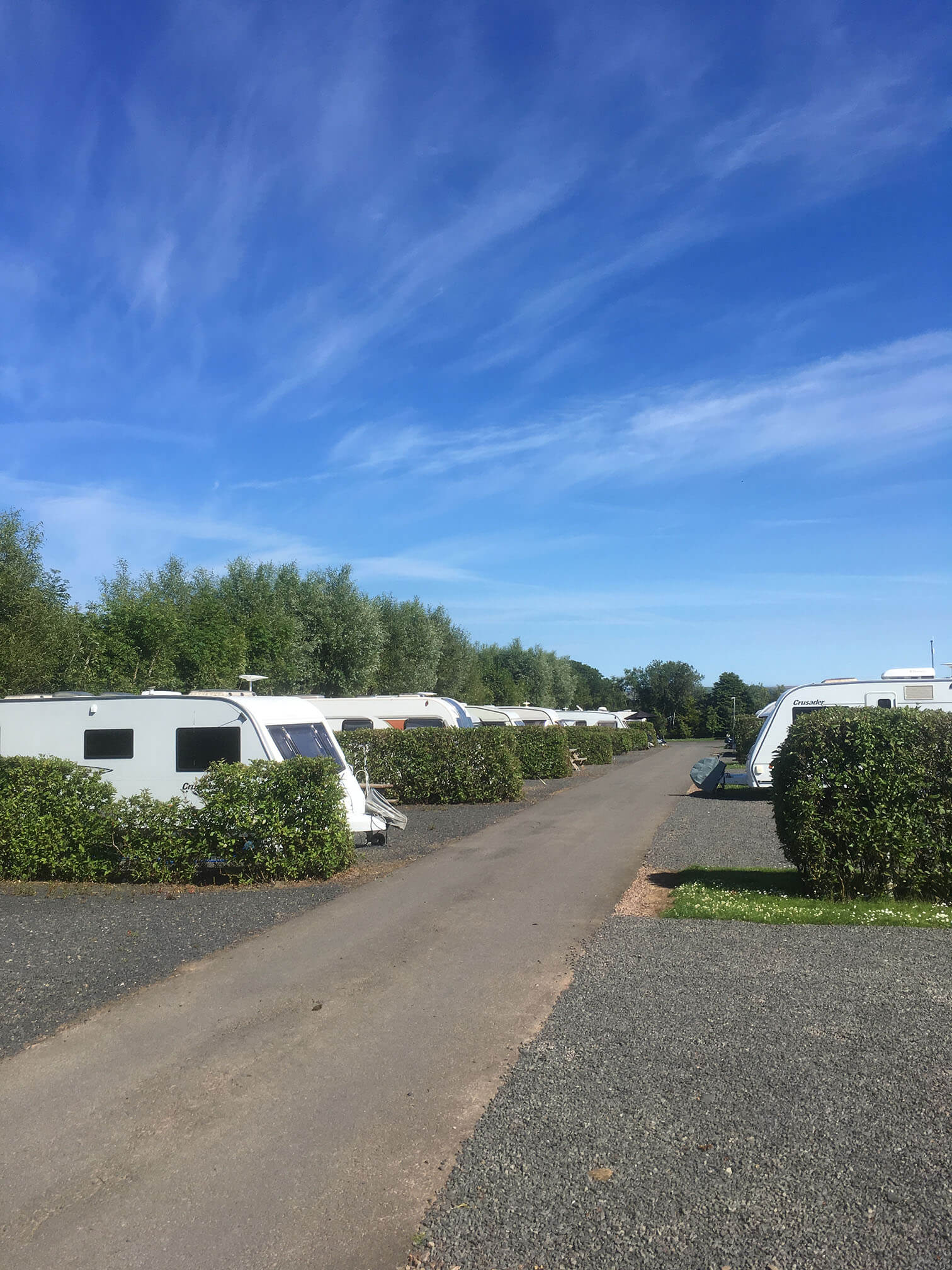 Touring vans and motorhomes at a UK holiday park 