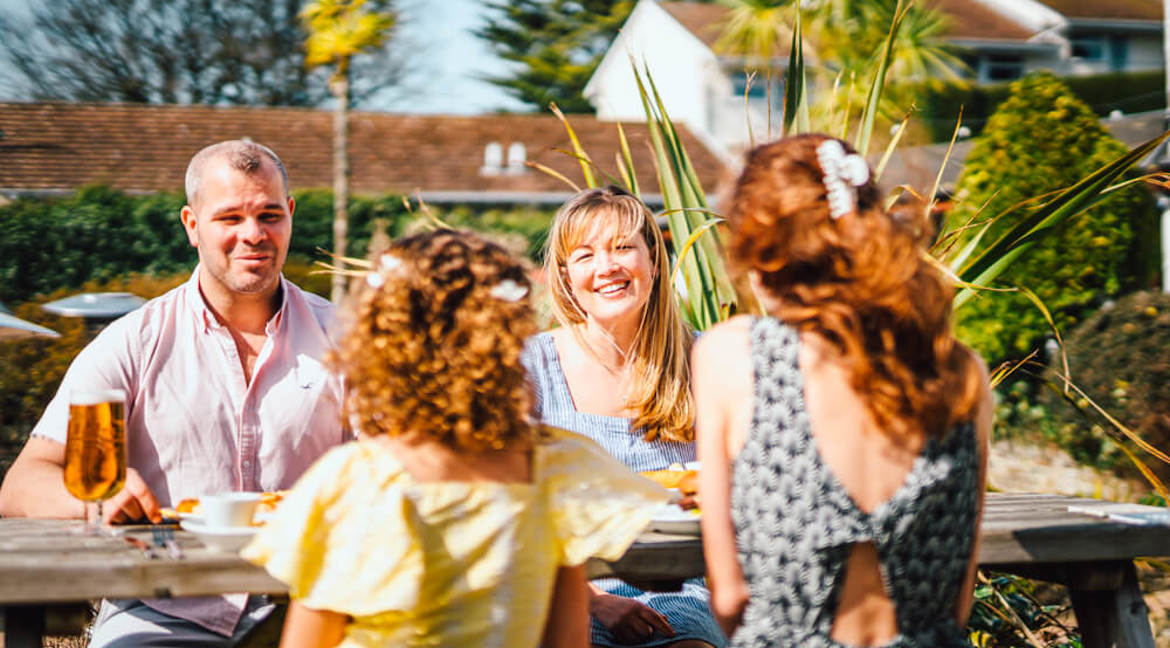 Family enjoying food and drinks outside The Old Mill in Woolacombe 